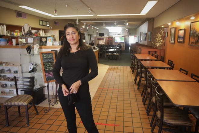 Owner Monica Schultz stands in the entrance of The Chile Pod restaurant in downtown Farmington. Schultz had served as a judge for the Farmington Chamber of Commerce's annual Chile in October event, and her eatery has won several awards in the competition.