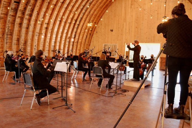 A crew member records a performance by members of the San Juan Symphony on Oct. 17, 2020, at the Reising Stage Event Center in Durango, Colo.