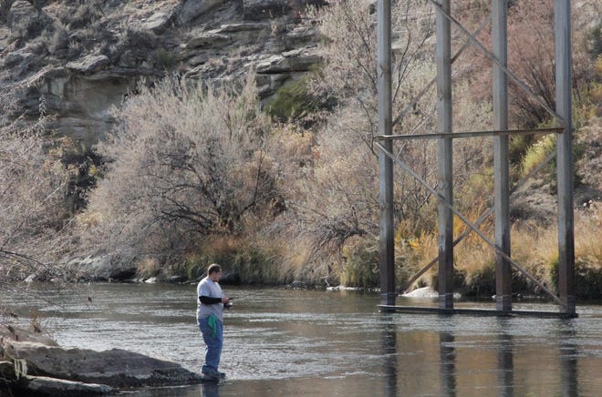 An angler fishes on the San Juan River, Friday, Nov. 6, 2020, downstream of Navajo Dam.
