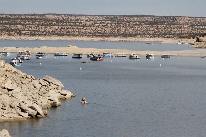 Boats are seen, Friday, Nov. 6, 2020, on Navajo Lake.