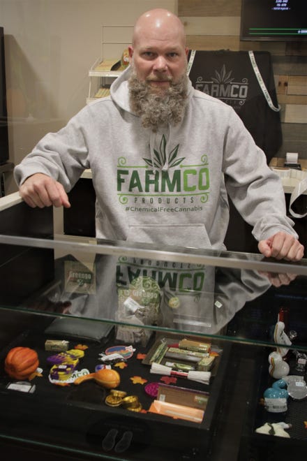 Jason Little of New Mexico Alternative Care stands behind the counter of his Farmington medical marijuana dispensary that will celebrate its 10th anniversary in December.