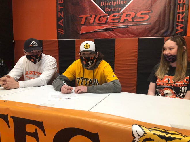 Aztec’s Sammy Minton signs his National Letter of Intent on Wednesday, Dec. 23, 2020, to continue his wrestling career at NAIA’s Ottawa University.