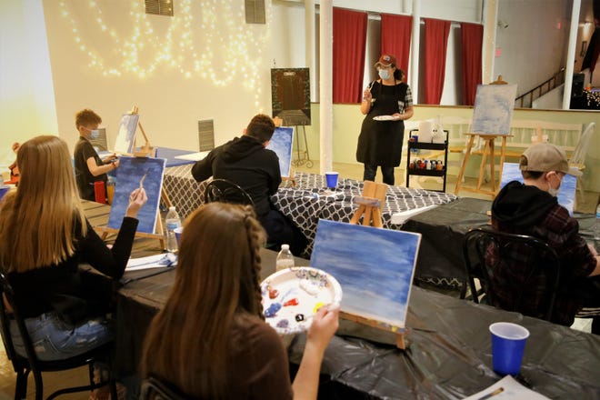 CEO Christy Clugston leads a painting class on Dec. 29, 2020, at the Aztec Theater, the new home of the nonprofit arts organization Inspire heART.