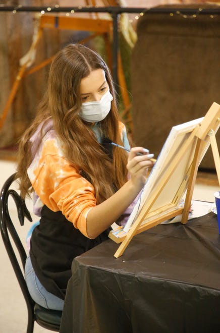 Student Jadyn Gardenhire works on her painting during a Dec. 29, 2020, class at Inspire heART at the Aztec Theater.