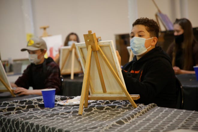 Jayden Fitzgerald, right, and other students work on their paintings during a Dec. 29, 2020, class at Inspire heART in Aztec.
