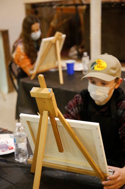Cody Clugston, front, and Jadyn Gardenhire work on their paintings during a Dec. 29, 2020, class at Inspire heART at the Aztec Theater.