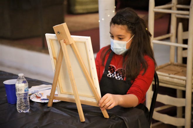 Student Emmie Fitzgerald works on her painting during a Dec. 29, 2020, class at Inspire heART at the Aztec Theater.
