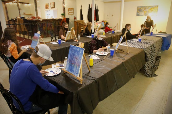 Students ranging in age from 10 to 15 take part in a painting class on Dec. 29, 2020, at Inspire heART headquarters at the Aztec Theater.