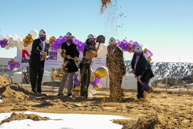Boomer Appleman, vice president for student services, left; Chris Harrelson, senior director of the physical plant; Toni Hopper Pendergrass, president; Joseph Rasor, chairman of the San Juan College Board of Trustees; and Edward DesPlas, executive vice president, all toss a shovelful of dirt during a groundbreaking ceremony for a new student housing project Feb. 19, 2021, on the college campus in Farmington.