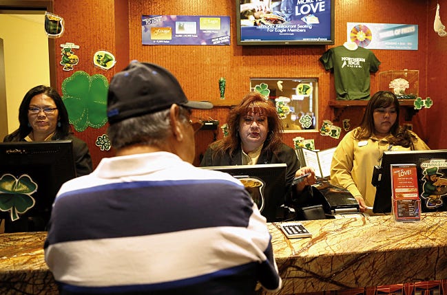 Players Club supervisor Muriel Nez, center, assists a patron on March 11, 2015 at Northern Edge Casino in Upper Fruitland. The Navajo Nation Gaming Enterprise will receive supplemental funding to help as casino closures continue.