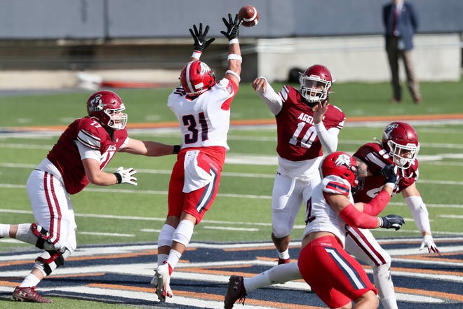 Jonah Johnson (10) passes as New Mexico State takes on Dixie State at the Sun Bowl in El Paso, Texas on Sunday, March 7, 2021.
