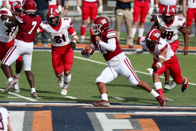 Jonah Johnson (10) scrambles as New Mexico State takes on Dixie State at the Sun Bowl in El Paso, Texas on Sunday, March 7, 2021.
