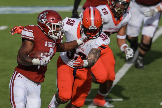 Juwaun Price (9) runs the ball as New Mexico State takes on Dixie State at the Sun Bowl in El Paso, Texas on Sunday, March 7, 2021.