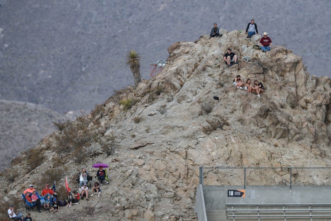 Fans hike the mountain behind the Sun Bowl stadium to watch New Mexico State take on Dixie State at the Sun Bowl in El Paso, Texas on Sunday, March 7, 2021.