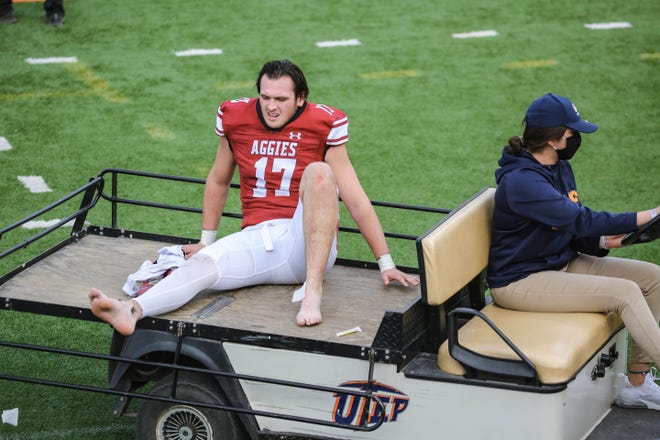 Weston Eget (17) is taken off the field on a cart after getting injured as New Mexico State takes on Dixie State at the Sun Bowl in El Paso, Texas on Sunday, March 7, 2021.