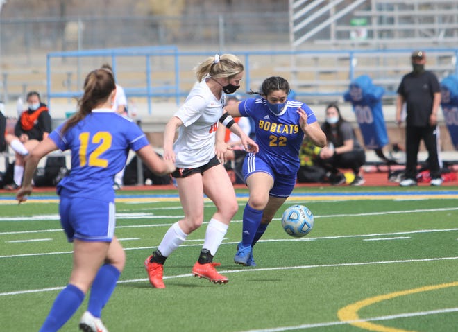 Aztec's Autumn Roundy tries to keep the ball away from Bloomfield's Haley Madrid on Saturday, March 6, 2021, at Bobcat Stadium in Bloomfield.