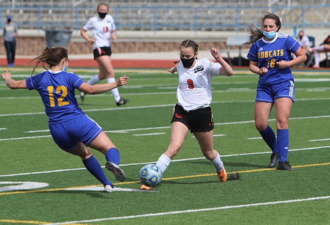 Aztec's Ashle Sexton controls the ball against Bloomfield's Kelli Radojits (12) on Saturday, March 6, 2021, at Bobcat Stadium in Bloomfield.