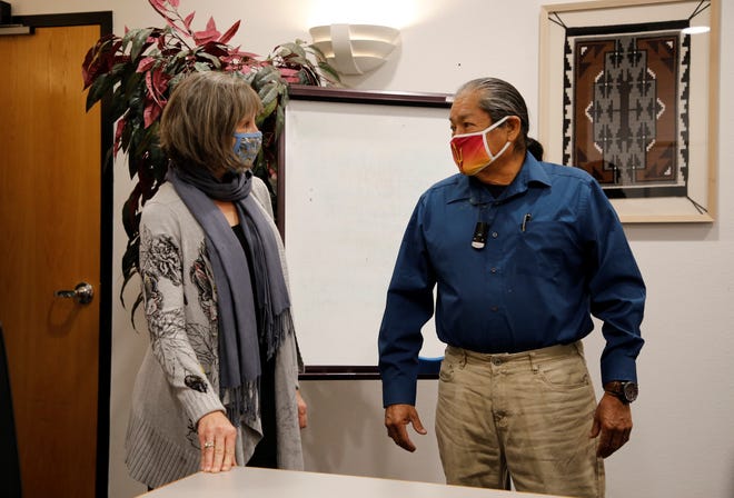 Jamie Church, Farmington Chamber of Commerce president and CEO, left, and Jeff Begay, board chairman of the Dineh Chamber of Commerce, talk on March 13 after signing the memorandum of understanding in Farmington.