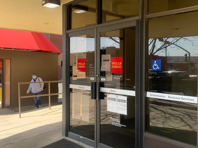 A person approaches the Wells Fargo Bank main branch  at 100 E. Broadway Ave. in Farmington on the afternoon of March 12, 2021. The branch will shut down at noon on Wednesday, June 2, 2021.
