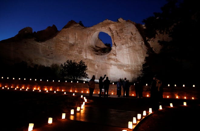 The Window Rock formation is illuminated on March 17 in Window Rock, Arizona during an event to remember members of the Navajo Nation who died of COVID-19.