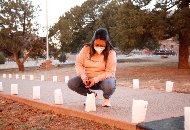 Sonya Begay, executive staff assistant with the Navajo Nation Office of the President and Vice President, lights a candle on March 17 in Window Rock, Arizona.
