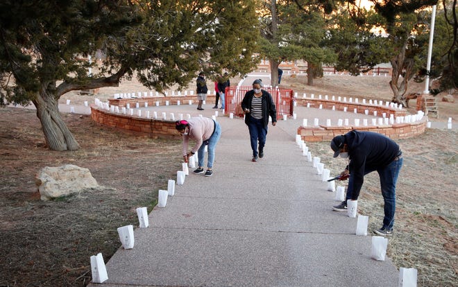 Navajo Nation Office of the President and Vice President employees and volunteers set up a display to remember 1,222 tribal members who died of COVID-19 in a memorial event on March 17 in Window Rock, Arizona.