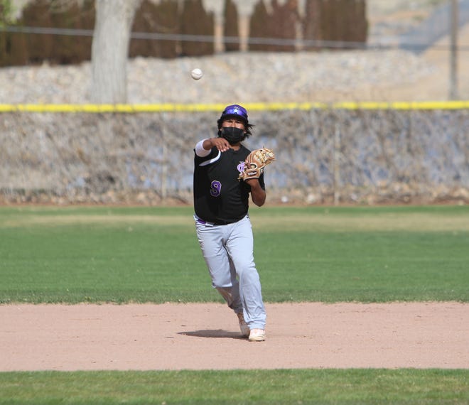 Kirtland Central's Ethan Yazzie throws to first base for an out against Farmington on Thursday, April 15, 2021, at Worley Field in Farmington.