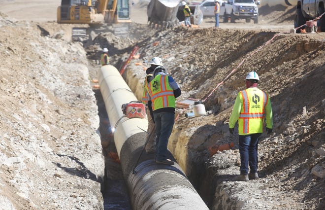 A type of concrete mix called controlled low-strength material is used to stabilize a pipe as part of the Navajo-Gallup Water Supply Project on April 15 in Newcomb.