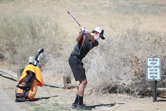 Aztec's JC Tavenner hits his ball from just behind the rough and down the fairway on the ninth hole during the Aztec Invitational on Monday, April 19, 2021, at Riverview Golf Course in Kirtland.