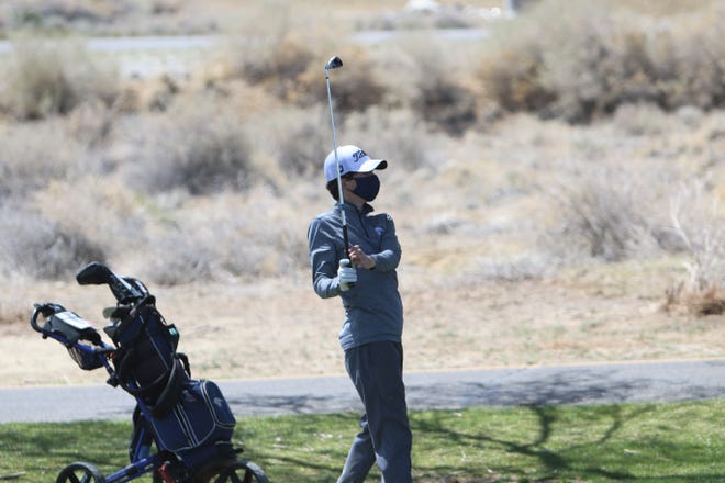 Piedra Vista’s Charlie Voita watches his ball head toward the ninth green during the Aztec Invitational on Monday, April 19, 2021, at Riverview Golf Course in Kirtland.