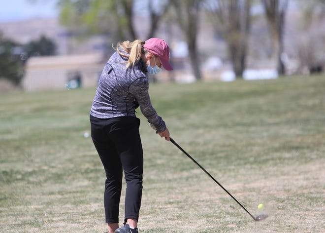 Piedra Vista’s Madyson Current hits her ball down the fairway on the eighth hole during the Aztec Invitational on Monday, April 19, 2021, at Riverview Golf Course in Kirtland.