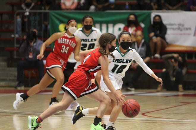Navajo Prep's Cienna Harrison looks to get a defensive stop against Robertson's Alexis Pacheco during the 3A state girls basketball finals on Friday, May 7, 2021, at The Pit in Albuquerque.