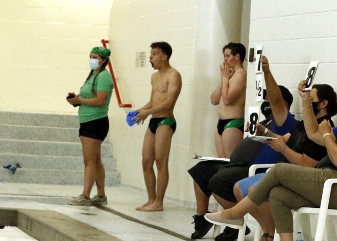 Farmington divers Eddie Durphy and Healaman Seavey react to teammate Mosiah Seavey's final dive of the day at the 2021 NMAA Swimming & Diving Championships at Albuquerque Academy on May 15, 2021. Mosiah Seavey won the state title with 470.15 points.