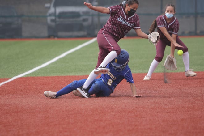 Bloomfield's Angel Campbell reaches third base by sliding underneath Shiprock's Harmony Sells (11) on Tuesday, May 18, 2021, at Bloomfield Softball Complex.