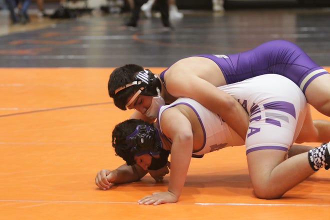 Kirtland Central's Byron Gibbs grabs hold of Miyamura's Sean Tafoya in a 182-pound division matchup during the District 1-4A wrestling championships on Saturday, May 22, 2021, at Lillywhite Gym in Aztec.