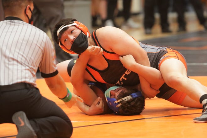 Aztec's Malcolm Altisi holds down Bloomfield's Steven Gallegos in a 182-pound division matchup during the District 1-4A wrestling championships on Saturday, May 22, 2021, at Lillywhite Gym in Aztec.