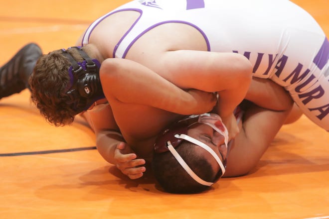 Shiprock's Cudia Tihe tries to free himself against Miyamura's Dominic Gutierrez during the District 1-4A wrestling championships on Saturday, May 22, 2021, at Lillywhite Gym in Aztec.