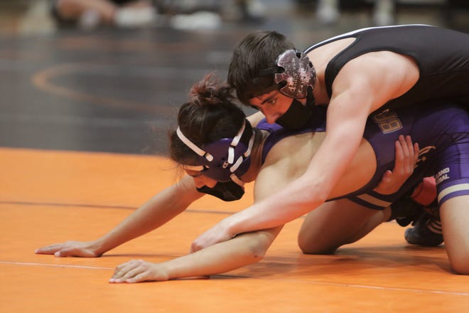 Aztec's Zach Sanders holds down Kirtland Central's David Iturralde in the 126-pound third place match during the District 1-4A wrestling championships on Saturday, May 22, 2021, at Lillywhite Gym in Aztec.