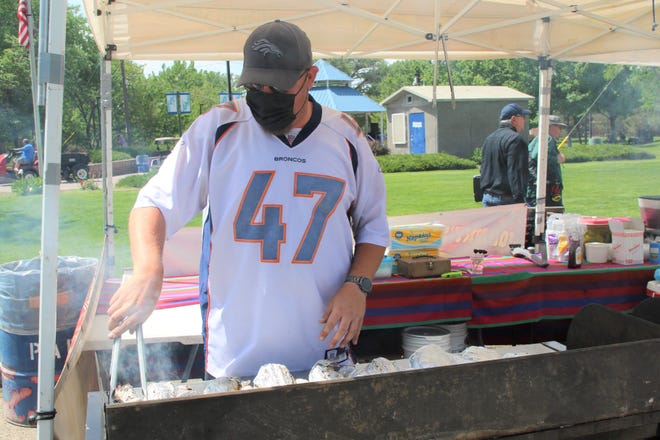 Jeff Day of Johnny's Jumbo Turkey Legs works the grill in Berg Park in Farmington on May 29. Food vendors are working the inaugural Animas River Jam in Animas and Berg parks on May 29 and 30.