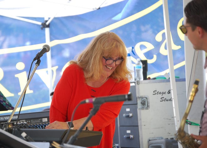 Pianist Robyn Woodard of the Fetz X-tet shares a laugh with saxophonist Alex Olivas during the band's performance on May 29, 2021, during the Animas River Jam.