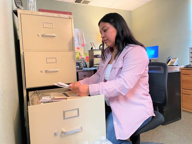 Childhaven forensic interviewer and family advocate Erica Woody examines files on June 9 at agency's 406 Airport Drive location in Farmington.