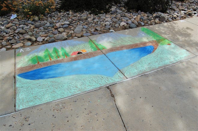 A two-section camping scene is pictured on the sidewalk on the east side of Farmington Public Library on June 10 during the Chalk Art Festival.