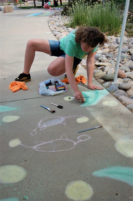 Lindon Vick applies shading to her entry in the Farmington Public Library's Chalk Art Festival on June 10.