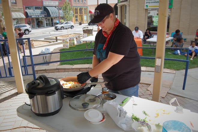 Chef Jacqueline Montoya prepares her lamb dish featuring stewed apricots, potatoes and carrots during the July 15 cook-off in Orchard Park in downtown Farmington.