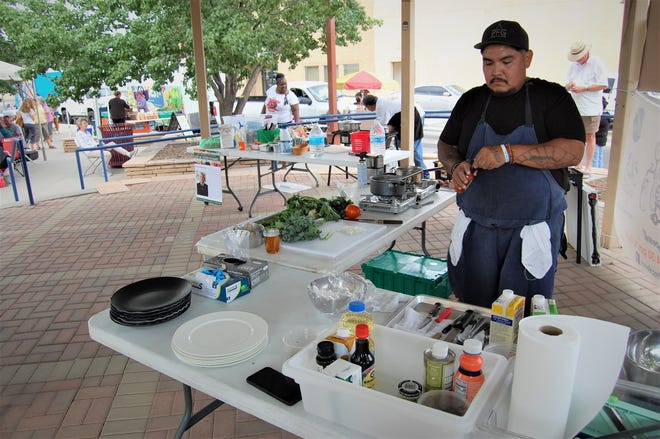 Chef Justin Pioche prepares some ingredients for his Navajo-inspired lamb dish during the Northwest New Mexico Local Food Summit cook-off July 15 in Orchard Park in downtown Farmington.