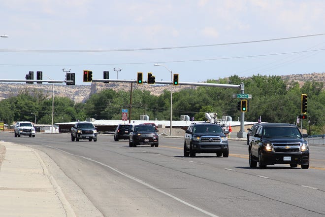 Vehicles taking part in the July 19 motorcade to escort family members of U.S. Army veteran Cecelia B. Finona to Shiprock drive through the intersection of West Apache Street and West Main Street in Farmington. Finona's remains arrived in Albuquerque earlier in the day.
