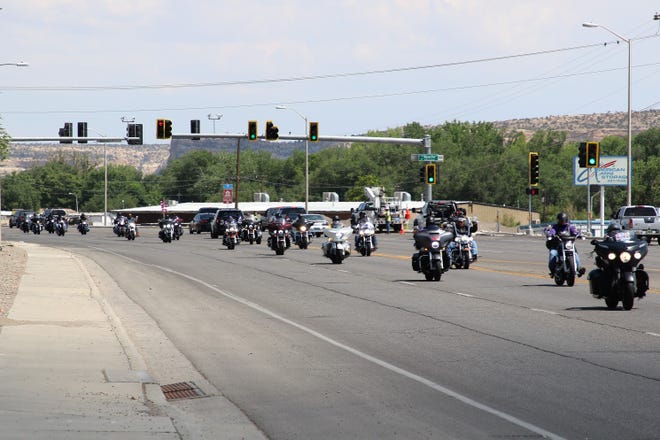 Members of the Navajo Hopi Honor Riders drive along West Main Street in Farmington to help escort family members of U.S. Army veteran Cecelia B. Finona to Shiprock after her remains arrive in Albuquerque on July 19.