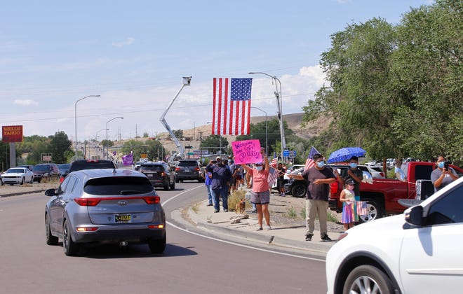 A procession on July 19 for the late U.S. Army veteran Cecelia B. Finona proceeds onto northbound U.S. Highway 491 in Shiprock.