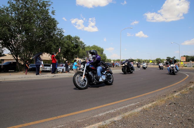 Members of the Navajo Hopi Honor Riders proceed onto U.S. Highway 491 in Shiprock to help escort family members of U.S. Army veteran Cecelia B. Finona after her remains arrive in Albuquerque on July 19.