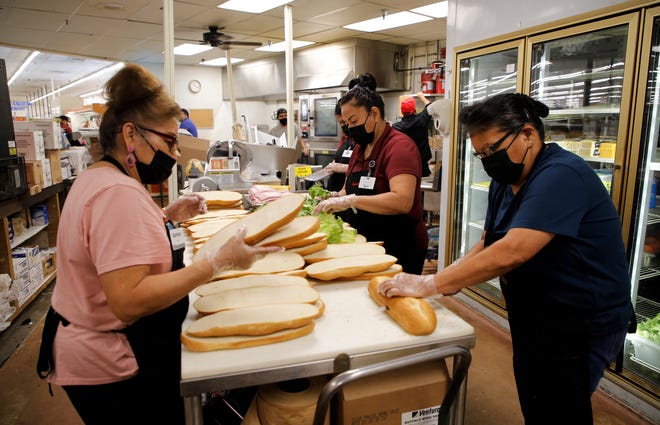 Barbara Toledo-Chambers, left, and Della Martin, right, help prepare sub sandwiches on July 20 in the deli section of the new Bashas' Diné Market in Shiprock. Both worked for City Market and joined Bashas' under the grocery store transition.